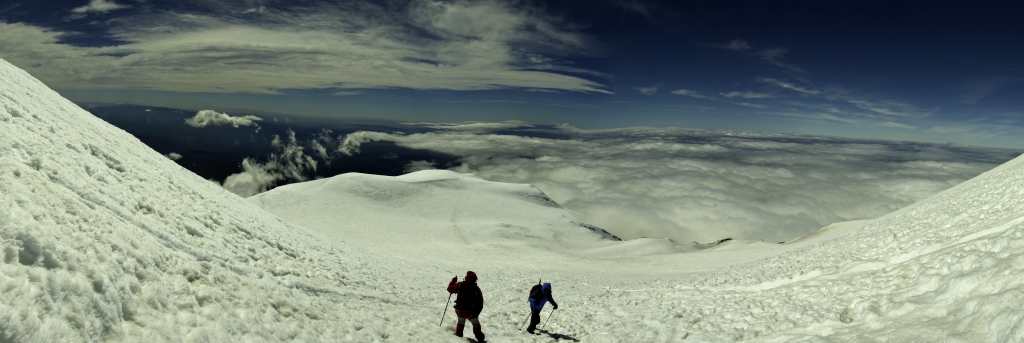 Panorama am höchsten erreichten Punkt am Mt. Adams (3743m) auf ca. 3700m (bei Wind in Sturmstärke mit über 100km/h Windgeschwindigkeit); Blick nach Süden über das (Vor-) Gipfelplateau auf Pikers Peak (3544m, auch False Summit genannt) und den aus den Wolken im Süden aufragenden Mt. Hood (3429m) neben dem sich links auch noch die Spitze des Mt. Jefferson (3191m) zeigt, Mt. Adams Wilderness, Washington