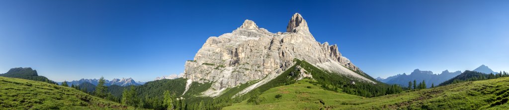 Früher Morgen auf der Ostseite des Pelmo (3168m) mit den drei Spitzen des Spiz de Mezzodi, dem Tame, dem Cima Nord di San Sebastian und den Ausläufern der Moiazza-Gruppe im Süden sowie den Ampezzaner Dolomiten, der Sorapis und dem Antelao im Norden. Dolomiten, Juli 2013.