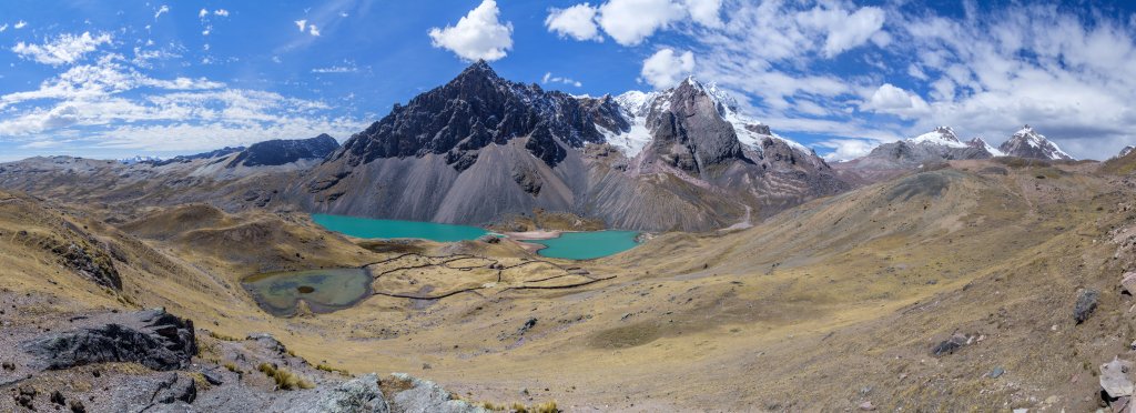 Die Umrundung des Ausangate vollendet sich - Alpaka-Hirten-Siedlung an der Laguna Comercocha und Laguna Caycocha vor dem Cerro Jatun Punta und Nevado Puca Punta (5750m) im Tal von Pachanta, Cordillera Vilcanota, Peru, Juli 2014.