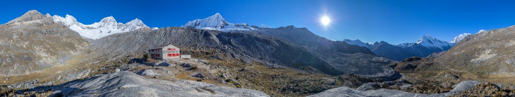360-Grad-Panorama bei Sonnenaufgang am Rifugio Peru (4680m) vor der weiten Bergkulisse der Gruppe der Huandoy's (6395m), des Pisco Oeste (5752m), des Nevado Yannapaccha (5460m), des Nevado Contrahierbas (6036m), des Nevado Chopicalqui (6354m) und den beiden hinter dem Bergrücken hervorlugenden Huascaran-Gipfeln (Sur - 6768m, Norte - 6655m), Cordillera Blanca, Peru, Juli 2014.