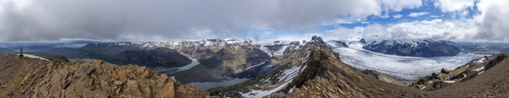 360-Grad-Panorama am Gipfel des Kristinartindar (1126m) mit Blick auf die Sandebene des Skeidararsandur, die Ausläufer des Skeidararjökull, die Bergkette des Skaftafellsfjöll, das Tal Morsadalur und den Morsarjökull mit seiner langgestreckten Gletscherlagune, die vom Vatnajökull herunterziehenden Hängegletscher, den vom Kristinartindar nach Nordosten zum Skardatindur (1365m) hinüber ziehenden scharfen Felsengrat, den Skaftafellsjökull sowie die gegenüberliegende Gipfelgruppe des Sveltiskard, Island, Juli 2015.