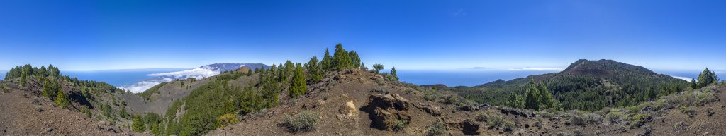 360-Grad-Panorama vom Montana la Barquito (1809m) über den San Juan Krater (1658m) und den Pico Birigoyo (1807m), dahinter die Randberge der Caldera de Taburiente, im Osten von La Palma sind Teneriffa und La Gomera zu sehen sowie im Süden die benachbarten Berge der Vulkan-Route mit dem Pico Nambroque (1922m) und dem Crater del Hoyo Negro (1886), hinter dem noch ein Teil von El Hierro hervorschaut, La Palma, Kanarische Inseln, Februar/März 2018.