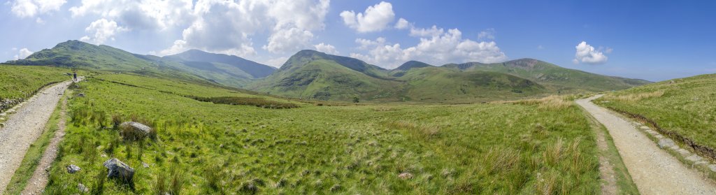 Besteigung des Snowdon (1085m), des höchsten Bergs von Wales, über den Llanberis Path entlang der Snowdon Mountain Railway von 1896 (einzige Zahnradbahn Grossbritanniens). Gegenüber der Moel Cynghorion (674m) und der Foel Goch (605m), Wales, Großbritannien, Juni 2018.