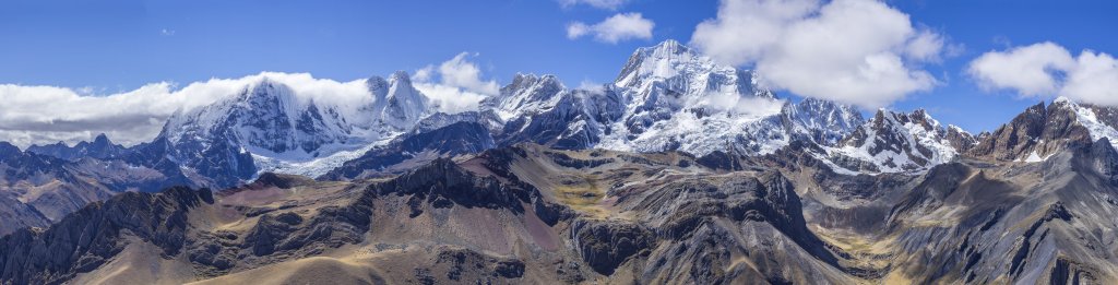 Sich ständig verändernde Wolken am Yerupaja (6635m) und eine Fönwalze über dem Rondoy (5775m) und Jirishanca (6094m) machen es nicht leicht, den perfekten Moment für das beeindruckende Gebirgspanorama der nördlichen Cordillera Huayhuash mit ihren hohen eisbedeckten 6000-ern über einer bunt gefärbten vulkanischen Felsenlandschaft zu erwischen, Peru, Juli 2019.