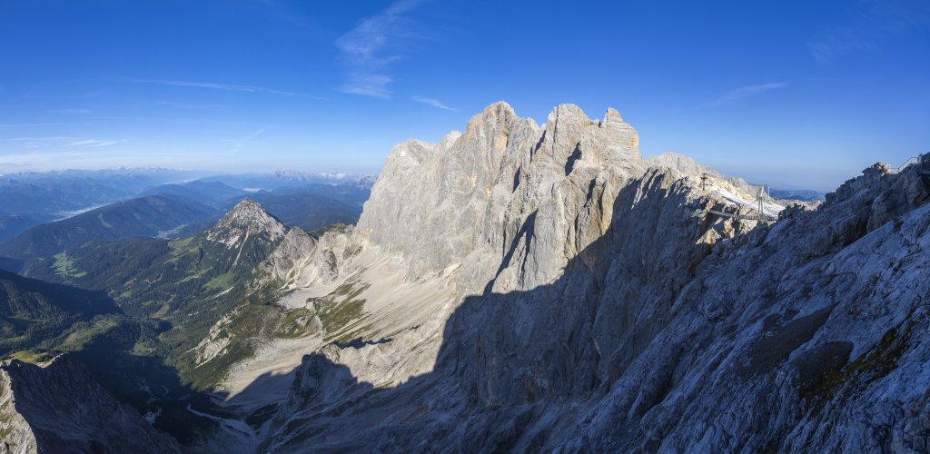 Perspektivwechsel - Panorama an der Bergstation der Hunerkogel-Bergbahn (2685m) mit Blick auf die fernen Gebirgskämme der Hohen Tauern, den langgestreckten bewaldeten Rücken des Schwemmbergs, Rettenstein, Rauhegg sowie die mächtige Dachstein-Südwand mit Torstein (2947m), Mitterspitz (2922m) und Hohem Dachstein (2995m), Hoher Dachstein, Österreich, September 2020.