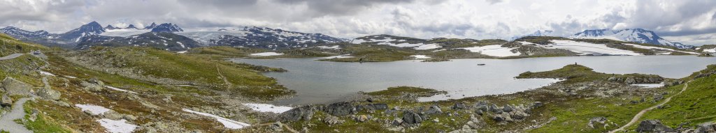 Blick am Pass der Sognefjellstraße über den Fantesteinsvatnet mit Leirbrean/Smoerstabbrean und den sich darüber erhebenden Smoerstabbtinden (2208m), Kniven (2133m), Sokse (2189m), Veslebjoern (2158m), Storebjoern (2222m), Gravdalstinden (2113m) auf der linken Seite sowie mit dem Fannaraki (2068m) und Steindalsnosi (1936m) über dem Fannarakbrean auf der rechten Seite, Norwegen, Juli 2022.