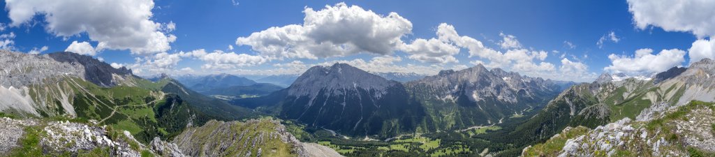 Panorama am Gipfel des Predigtsteins (2234m) mit weitem Rundumblick auf die Südflanke des Wetterstein Gebirges mit der vorgelagerten Gehrenspitze (2367m), der Rotmoosalm (1904m), dem westlichen Karwendelgebirge bei Seefeld, dem Inntal, Leutasch und dem Gaistal, der Hohen Munde (2662m), der Hohen Wand (2719m) und den weiteren westlicheren Bergen des Mieminger Gebirges, dem Wannigjöchl (2186m), Schneefernerkopf (2874m), Schneeferner und Zugspitze (2962m), Wetterstein Gebirge, Österreich, Juni 2014.