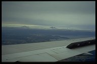 Im Anflug auf Puerto Montt - aus den Wolken ragen der Osorno (2660m), der Calbuco (2015m) und der Tronador (3554m)